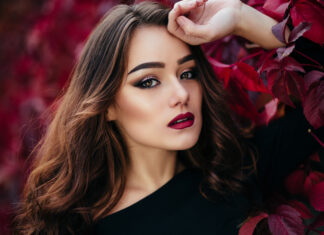 Makeup Inspirations For A Winter Wedding 2023 The beautiful girl stands near walll with leaves-WeddingAffair